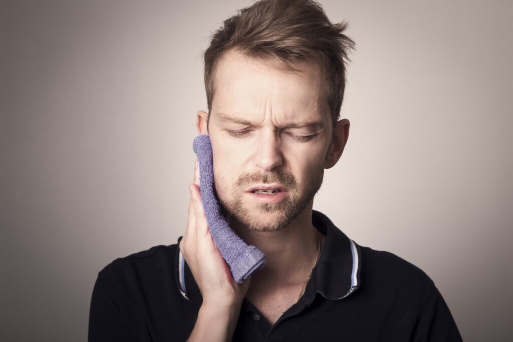 A man holding his hand to his ear